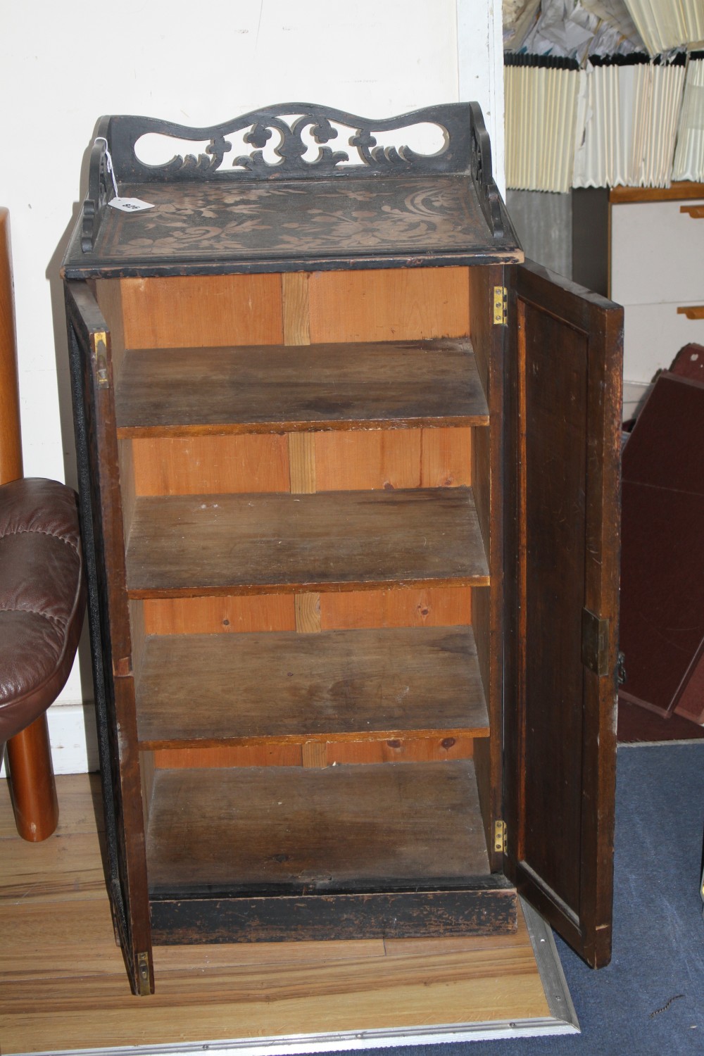 An Edwardian ebonised music cupboard, with floral pokerwork decoration, W.47cm D.35cm H.91cm